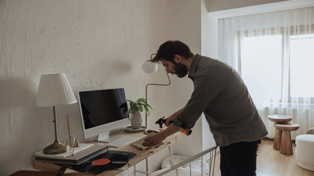 A man cleaning up his workspace