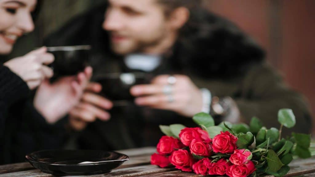 A couple talking closely at a cafe