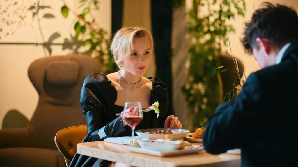 A woman having dinner with a man at a restaurant.