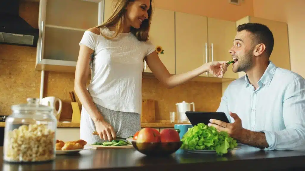 A man and woman at the kitchen