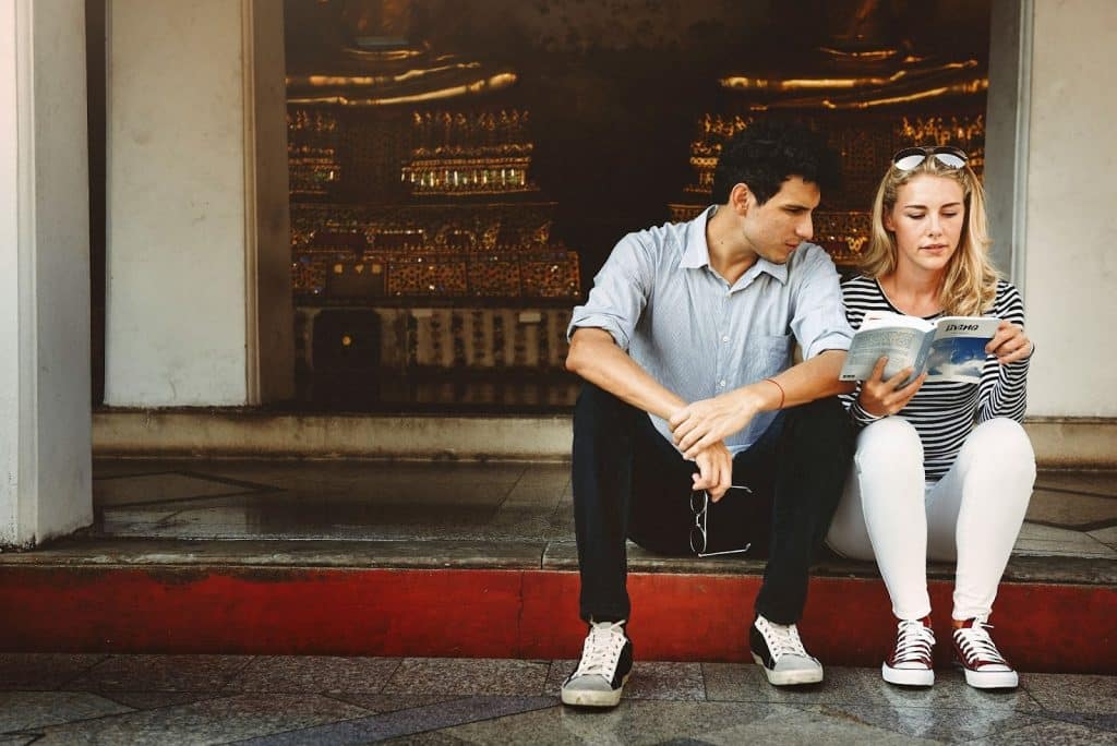 A man and woman sitting and looking at the brochure