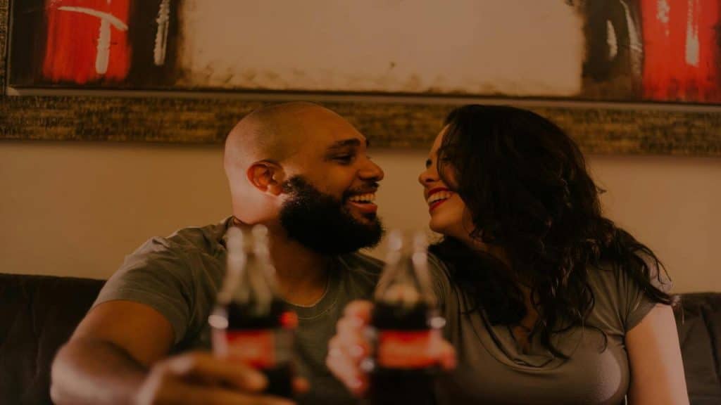 A couple laughing while drinking beer