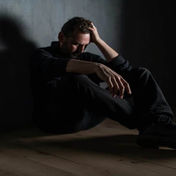 A man sitting alone in the dark