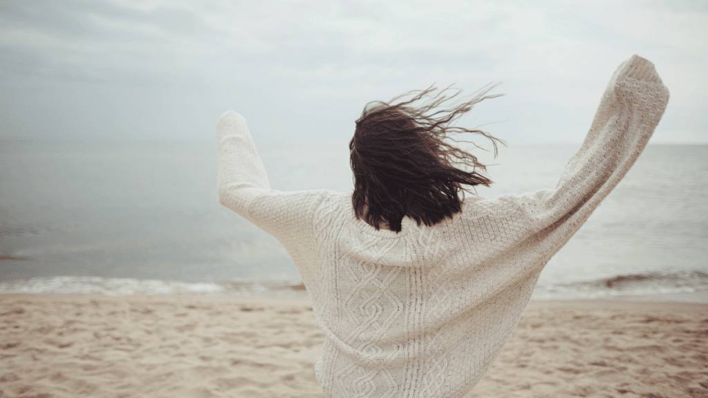 A woman celebrating at the beach