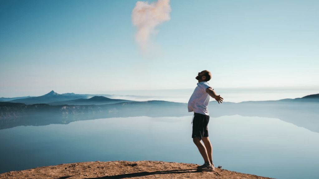 A man looking happy by a lake