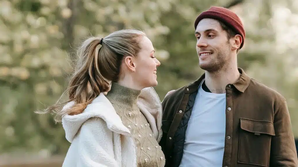 Smiling couple looking at each other outdoors.