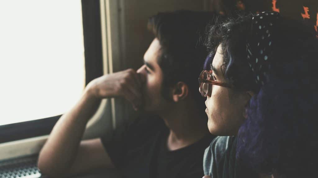 A couple looking out a train window.