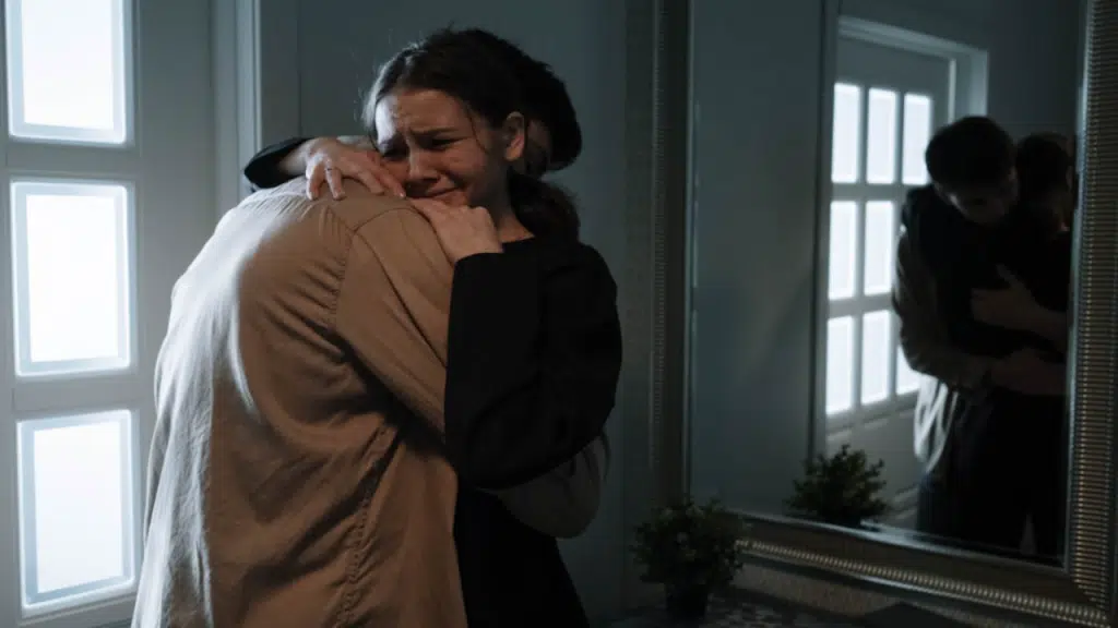A man comforting his crying wife