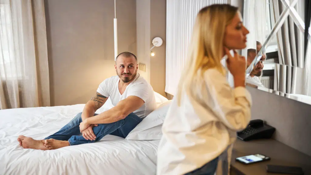 A man watching his wife getting ready