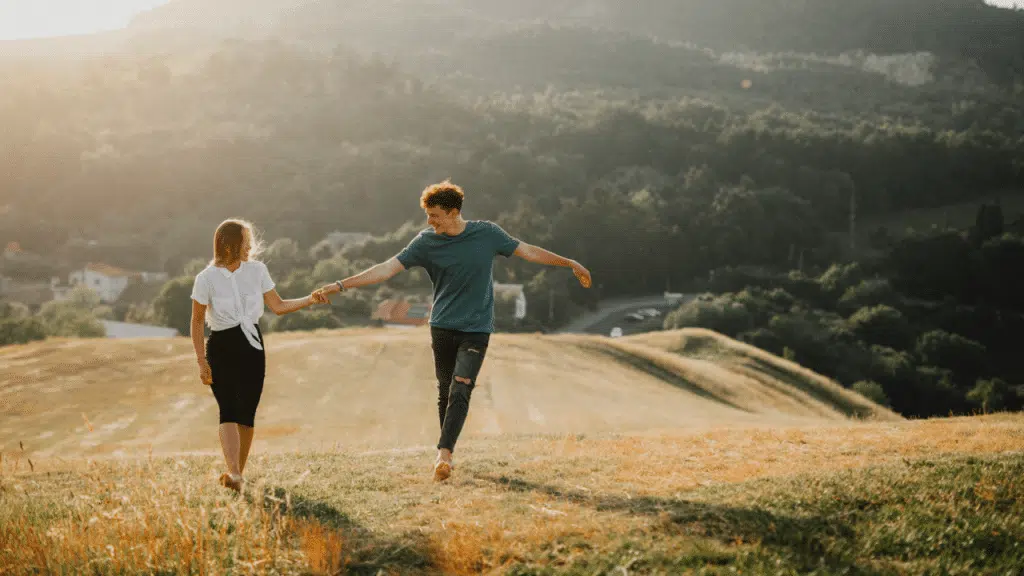 A couple holding hands on a field