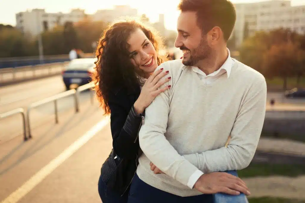 A woman hugging a man