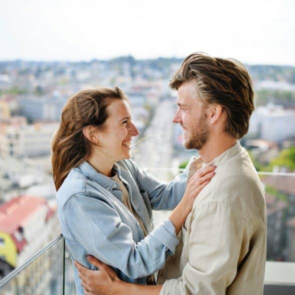A man and woman smiling at each other