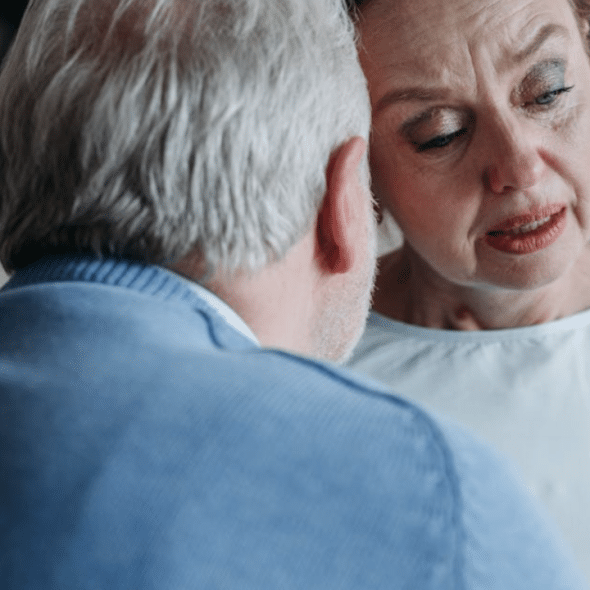 A man comforting his crying wife