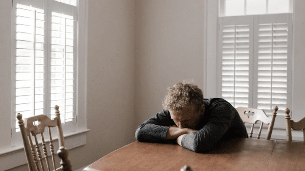 A man looking sad at home