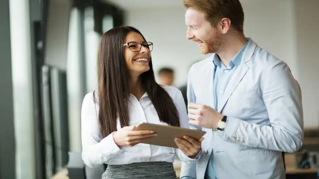 Colleagues laughing with each other in the office