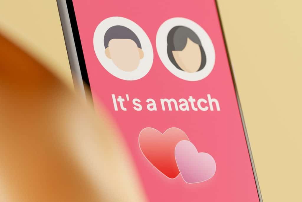 A photo of a cellphone with a dating app on the screen.