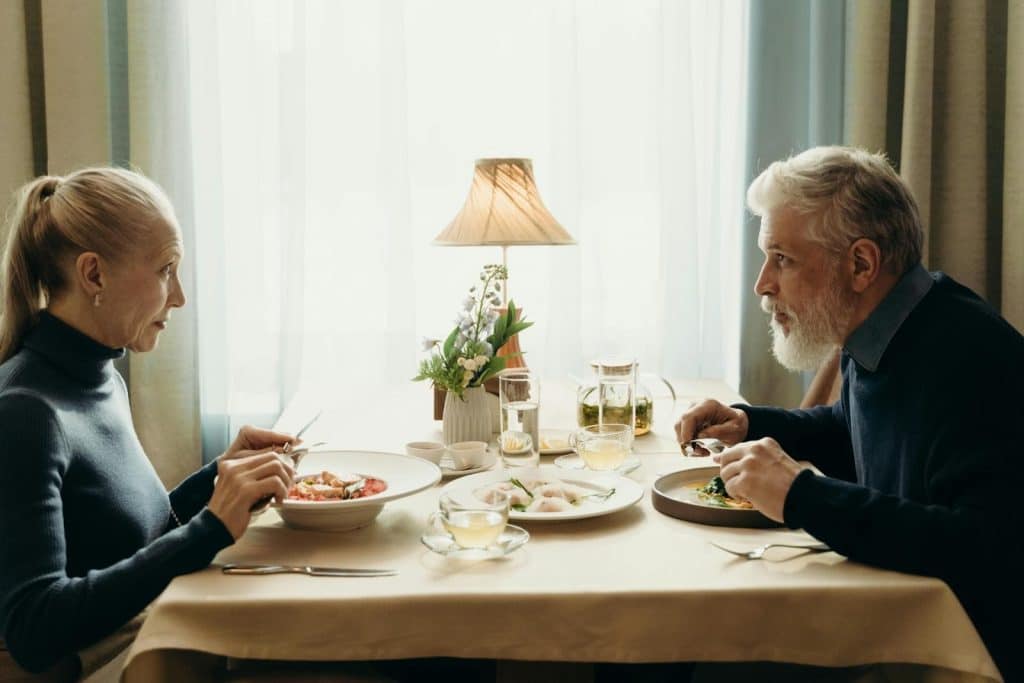 A couple talking while having a meal.