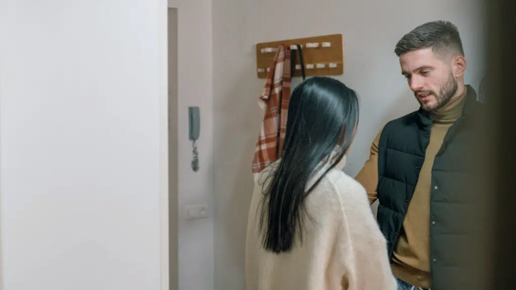 A couple having a serious talk by the entryway
