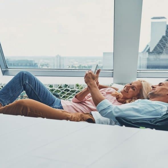 A couple relaxing on a hammock