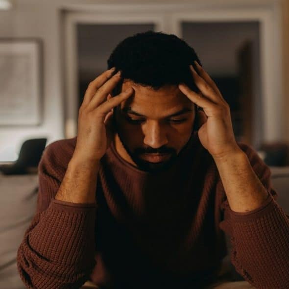 A man looking stressed at home