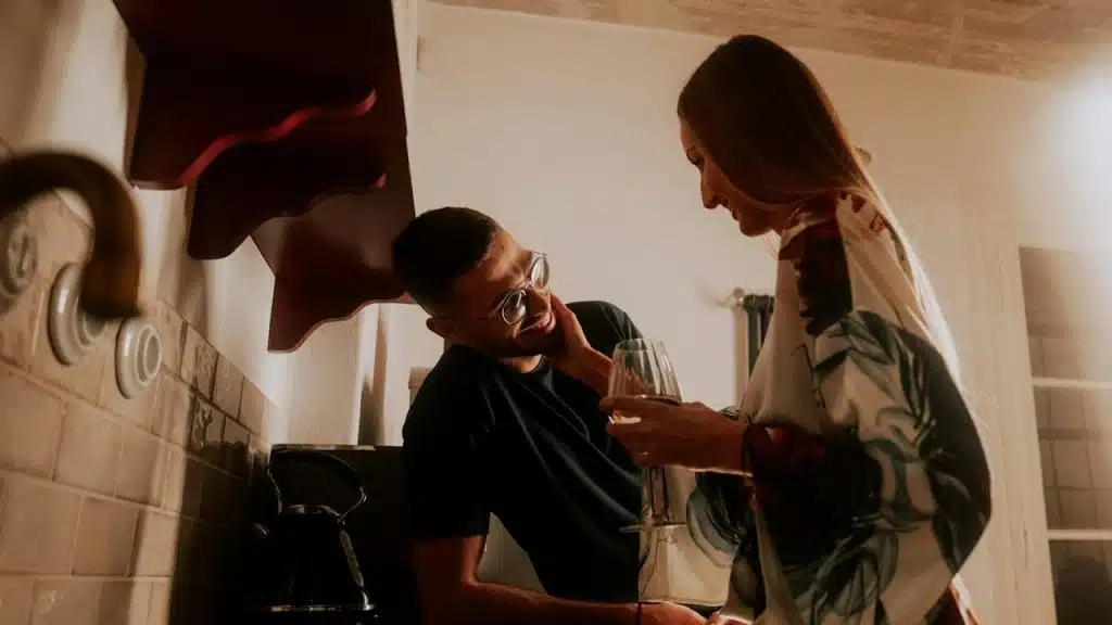 A couple flirting in a kitchen.