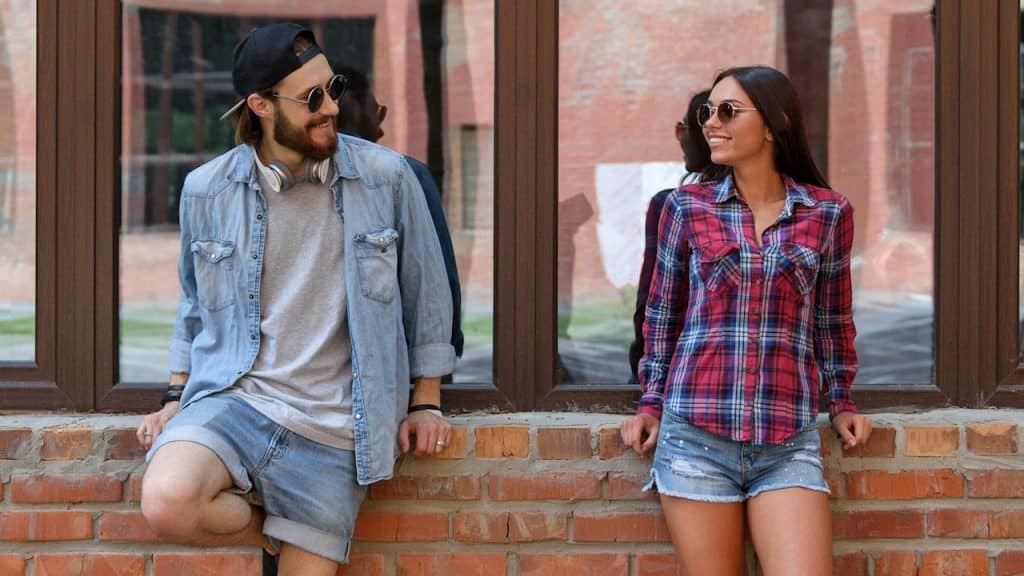 Joyful young man and woman are talking and flirting.