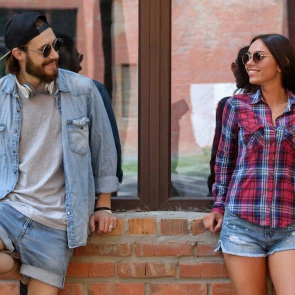 Joyful young man and woman are talking and flirting.