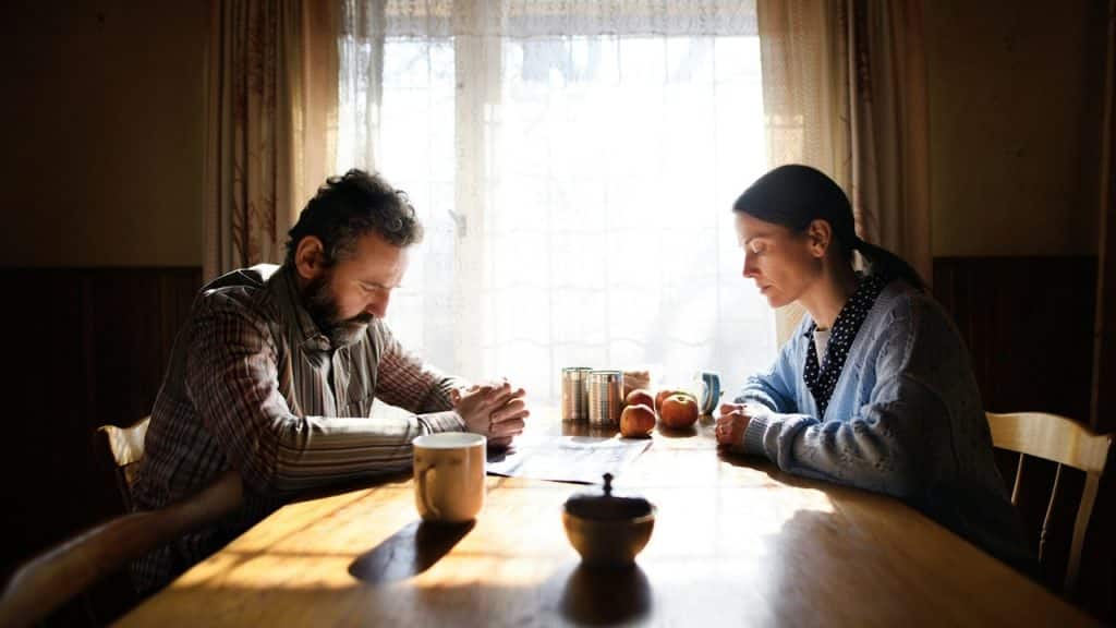 A man and a woman sitting at a table.