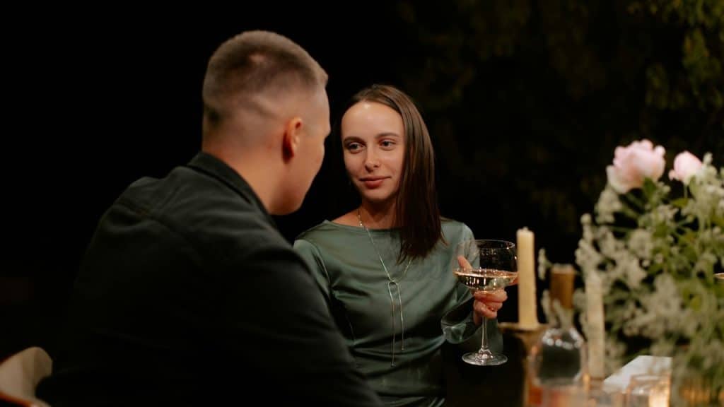 A man and a woman sitting at a dinner table.