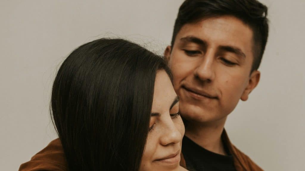 A man and a woman embracing each other.