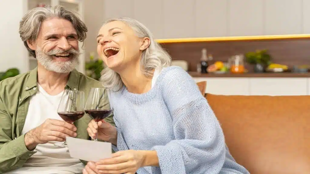 A mature couple having wine together
