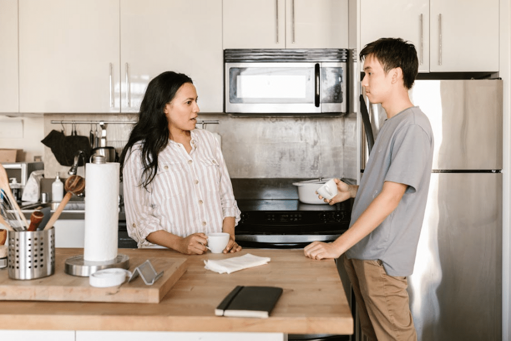 A couple talking in the kitchen
