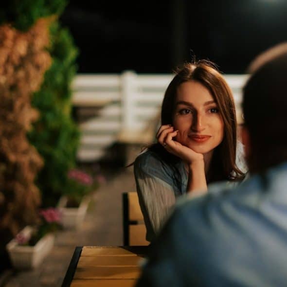 A man staring at a man with intensity and curiosity.