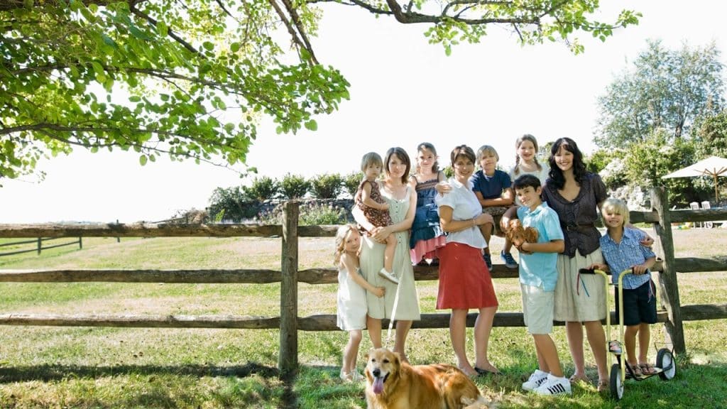 A group of people standing in a farm house.