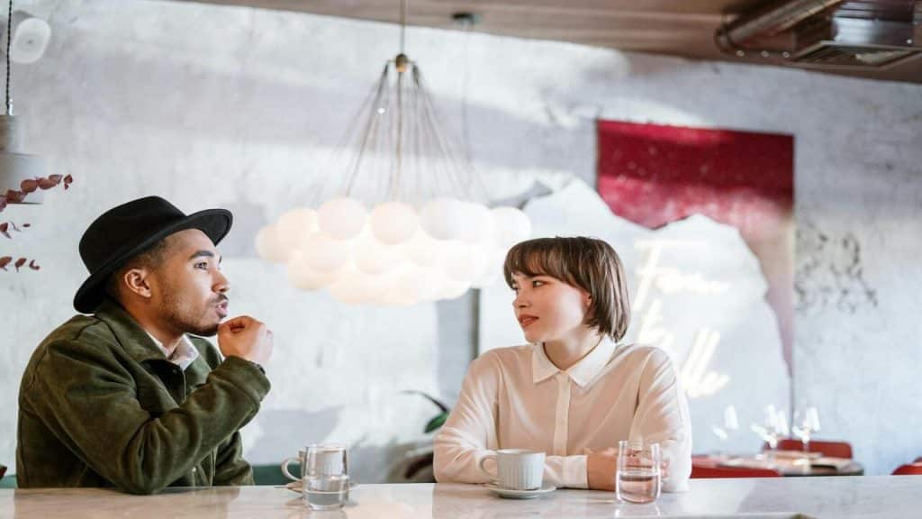 A man and a woman having coffee together