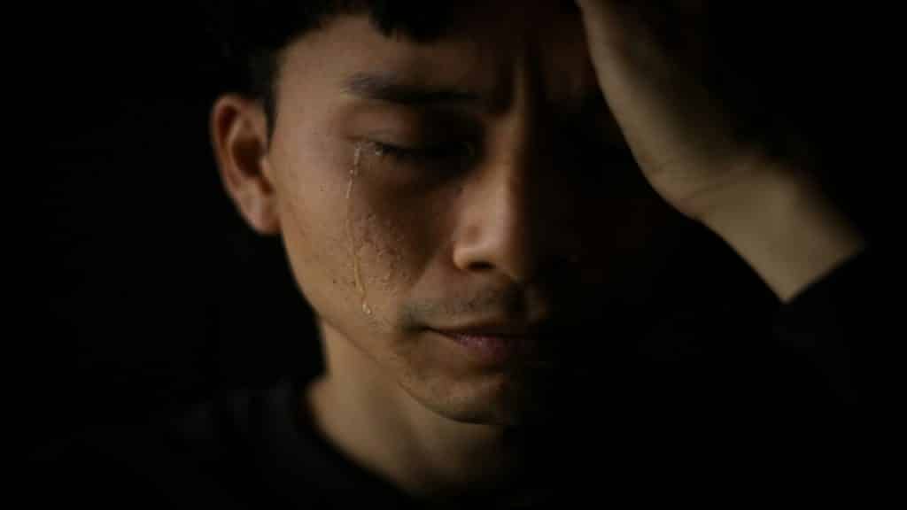 A man crying in the dark