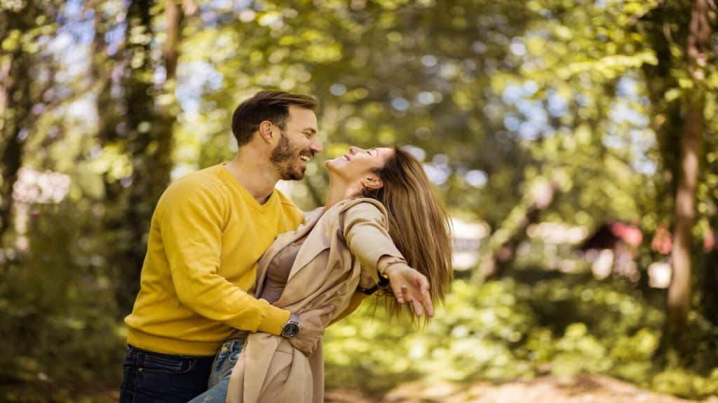 A couple hugging outdoors