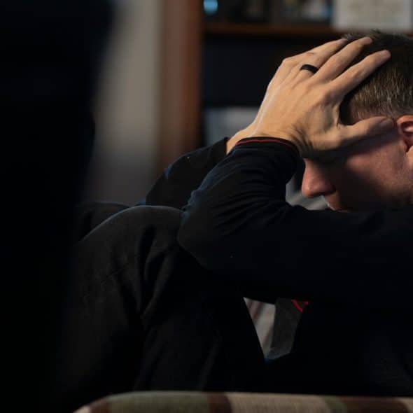 A man looking frustrated at home