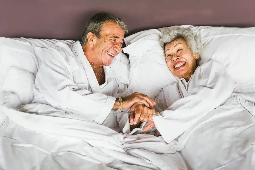 A man and woman at the bed