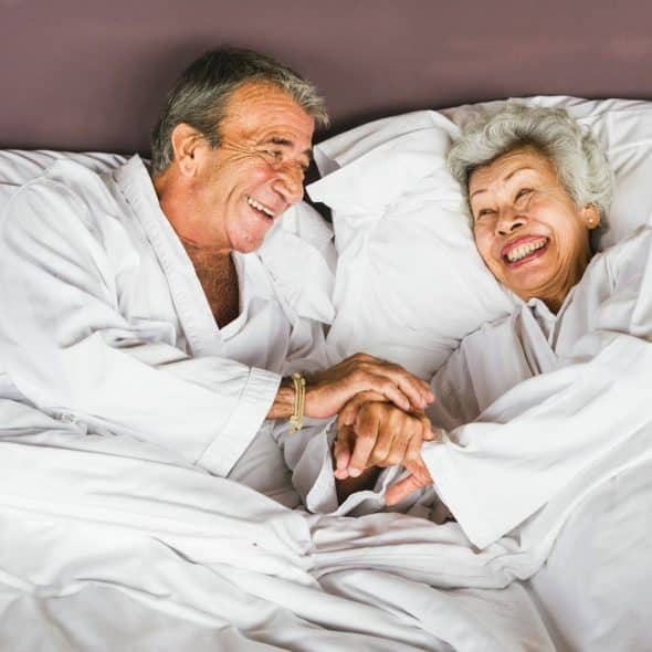 A man and woman at the bed