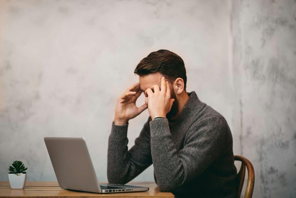 A man holding his head