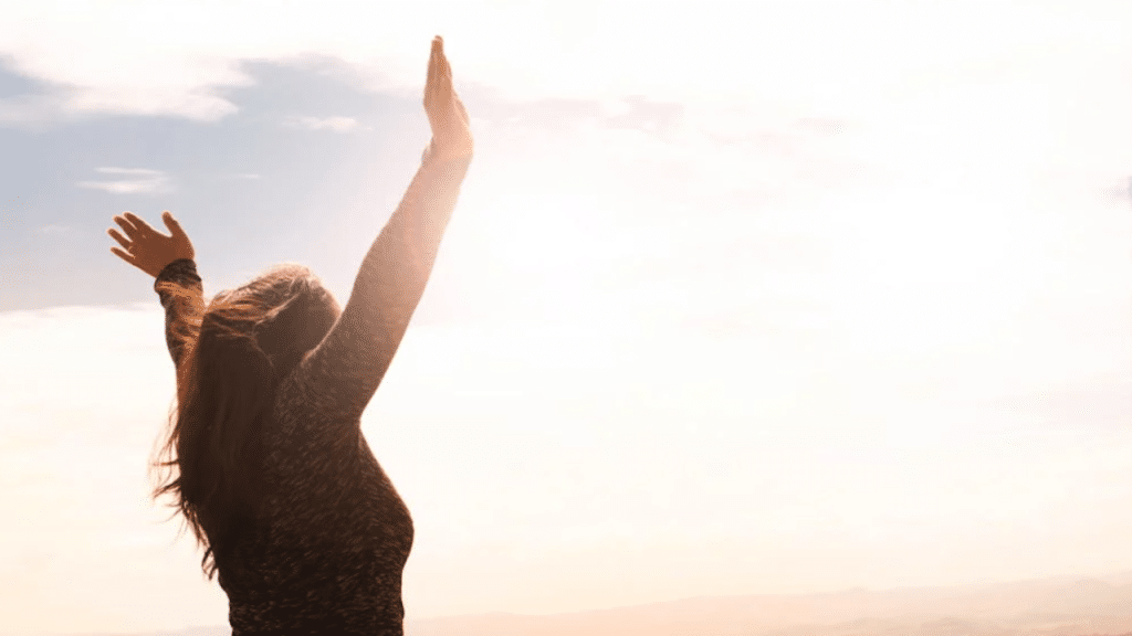 A woman raising her hands to the sky