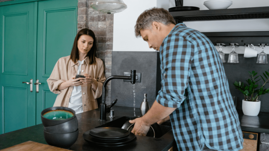 A couple talking by the sink