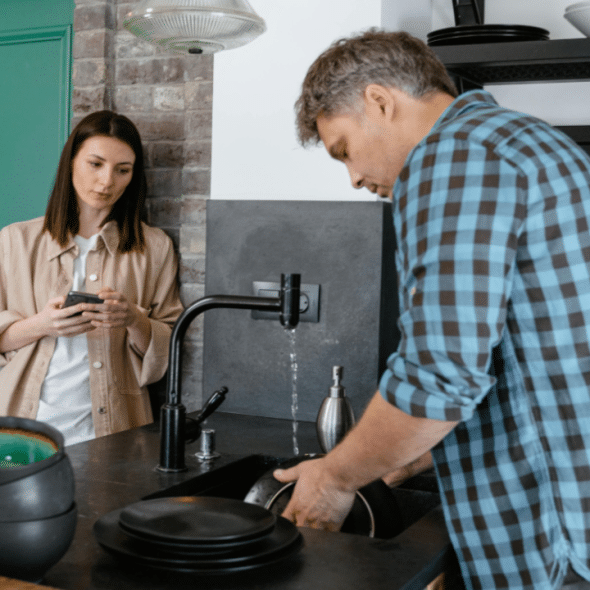 A couple talking by the sink