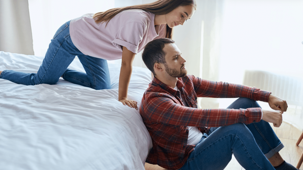 An upset man ignoring his wife