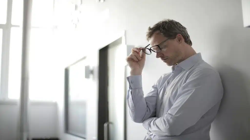 A man looking upset at a hallway