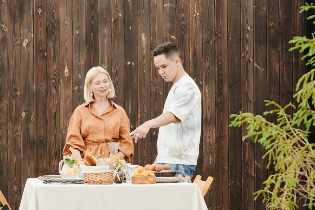 A man and a woman standing in front of a table