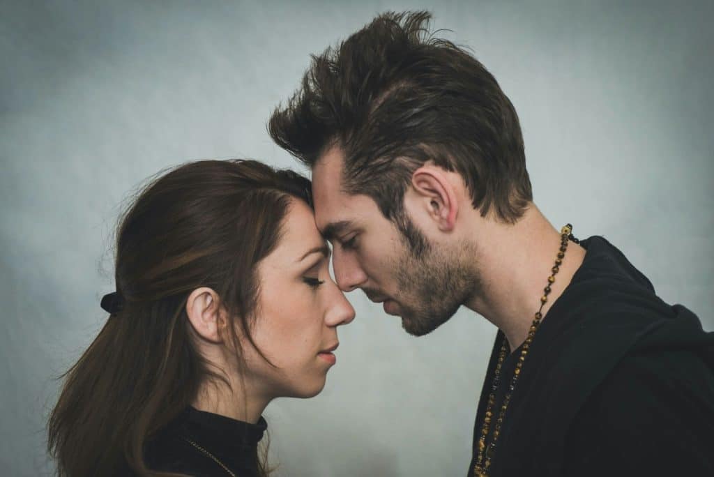 A man and woman facing each other 