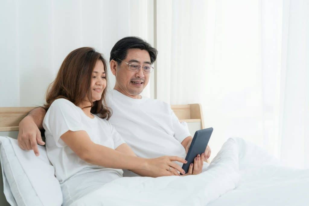 A man and woman at the bed
