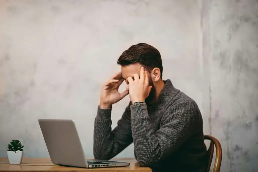 A man holding his head